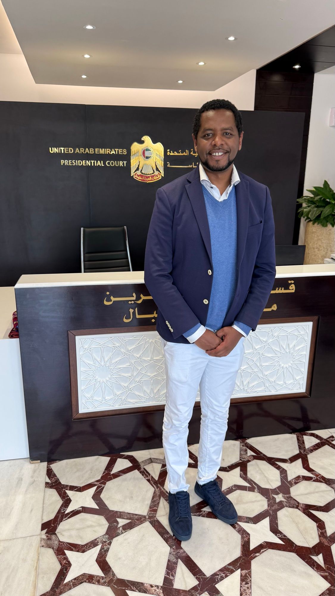 Michel Tzsfaldet standing at the United Arab Emirates Presidential Court in Abu Dhabi.